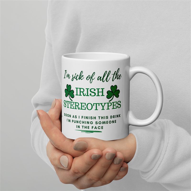 White novelty mug with green Irish-themed typography held against a light background